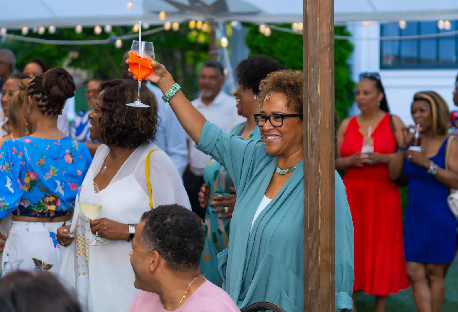 Guests raising a toast at an outdoor garden reception