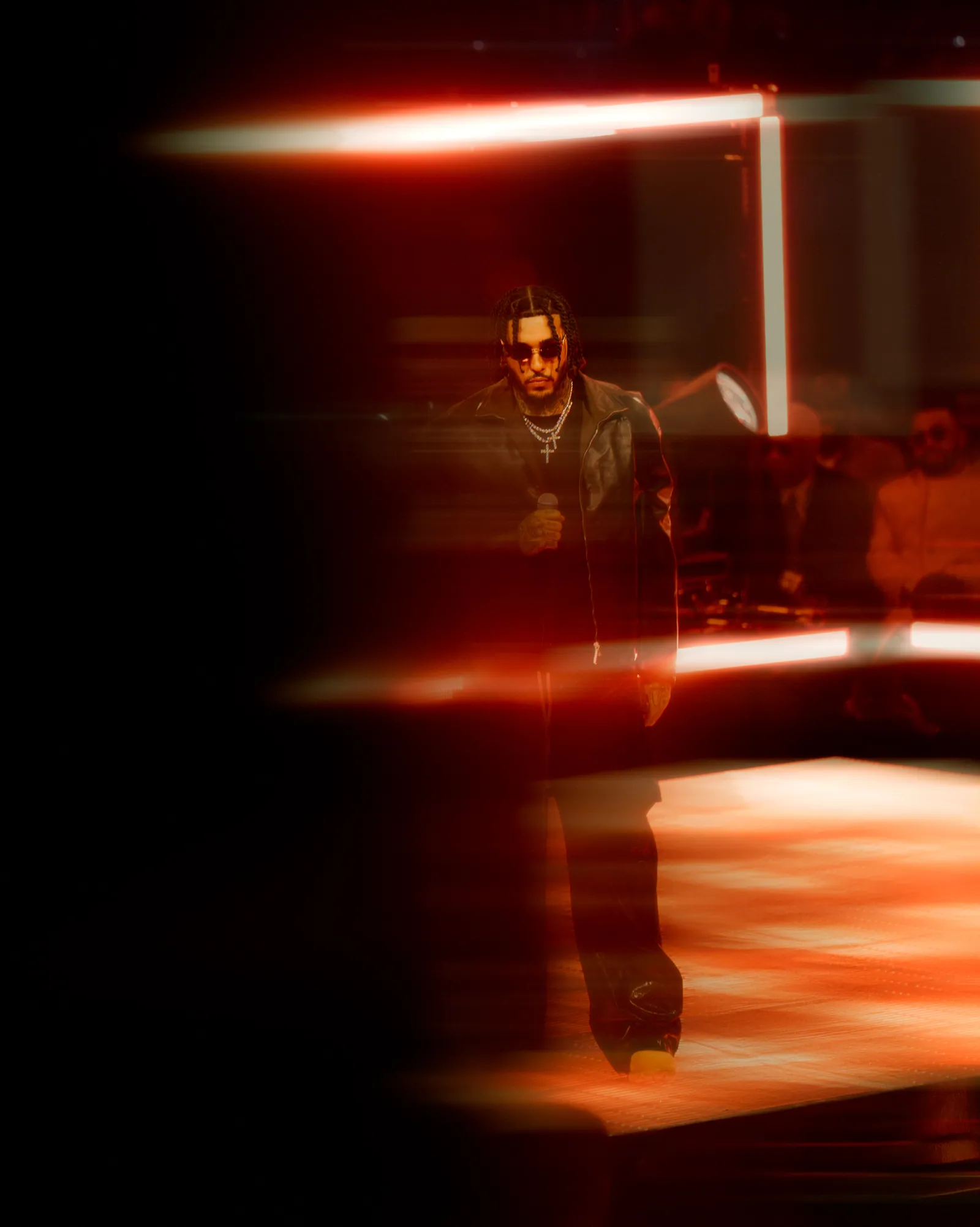 Performer silhouetted in dramatic red stage lighting at the 2025 NBA All-Star Weekend at Chase Center