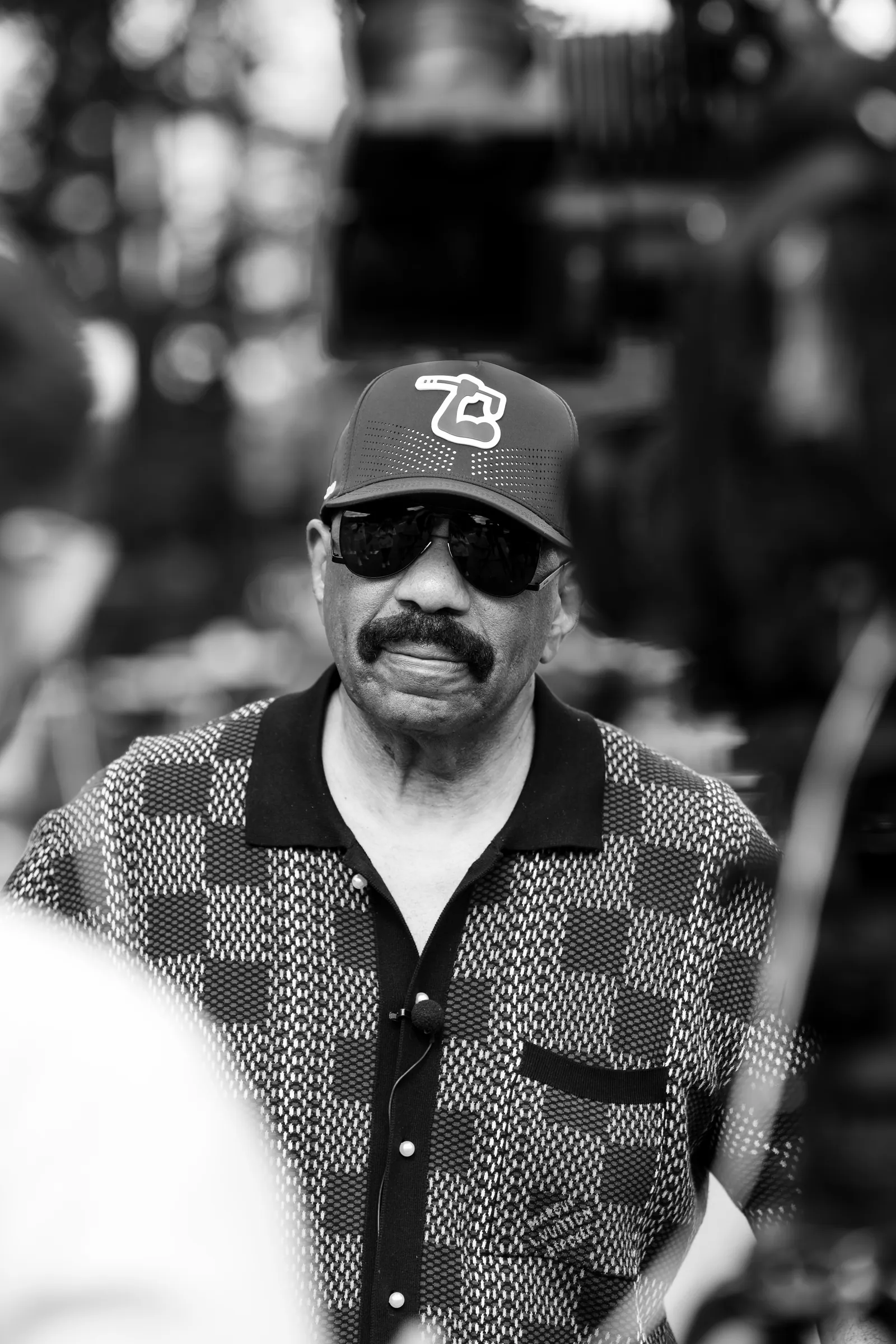 Black and white portrait of Steve Harvey at the golf tournament