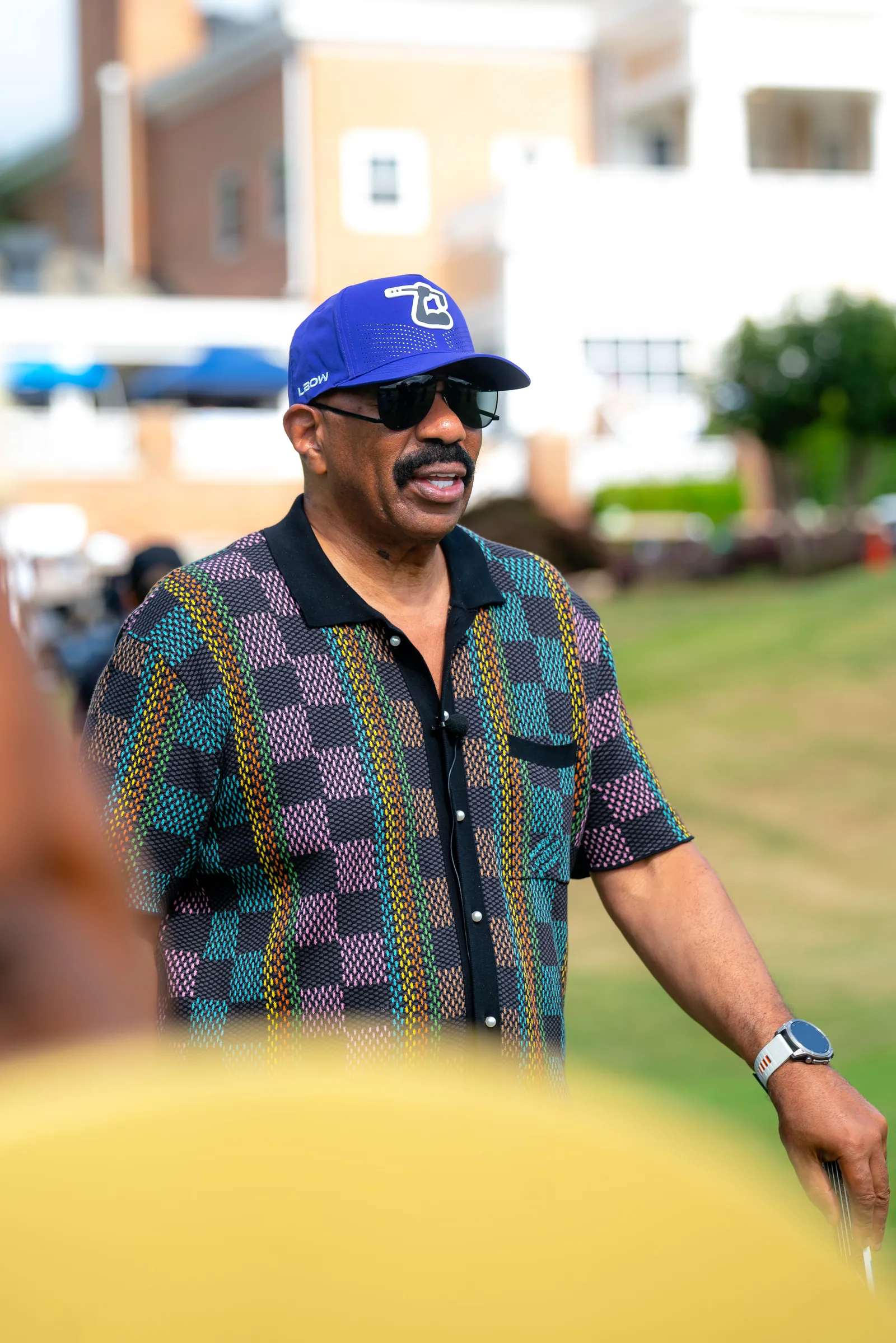 Steve Harvey between holes at the charity golf tournament
