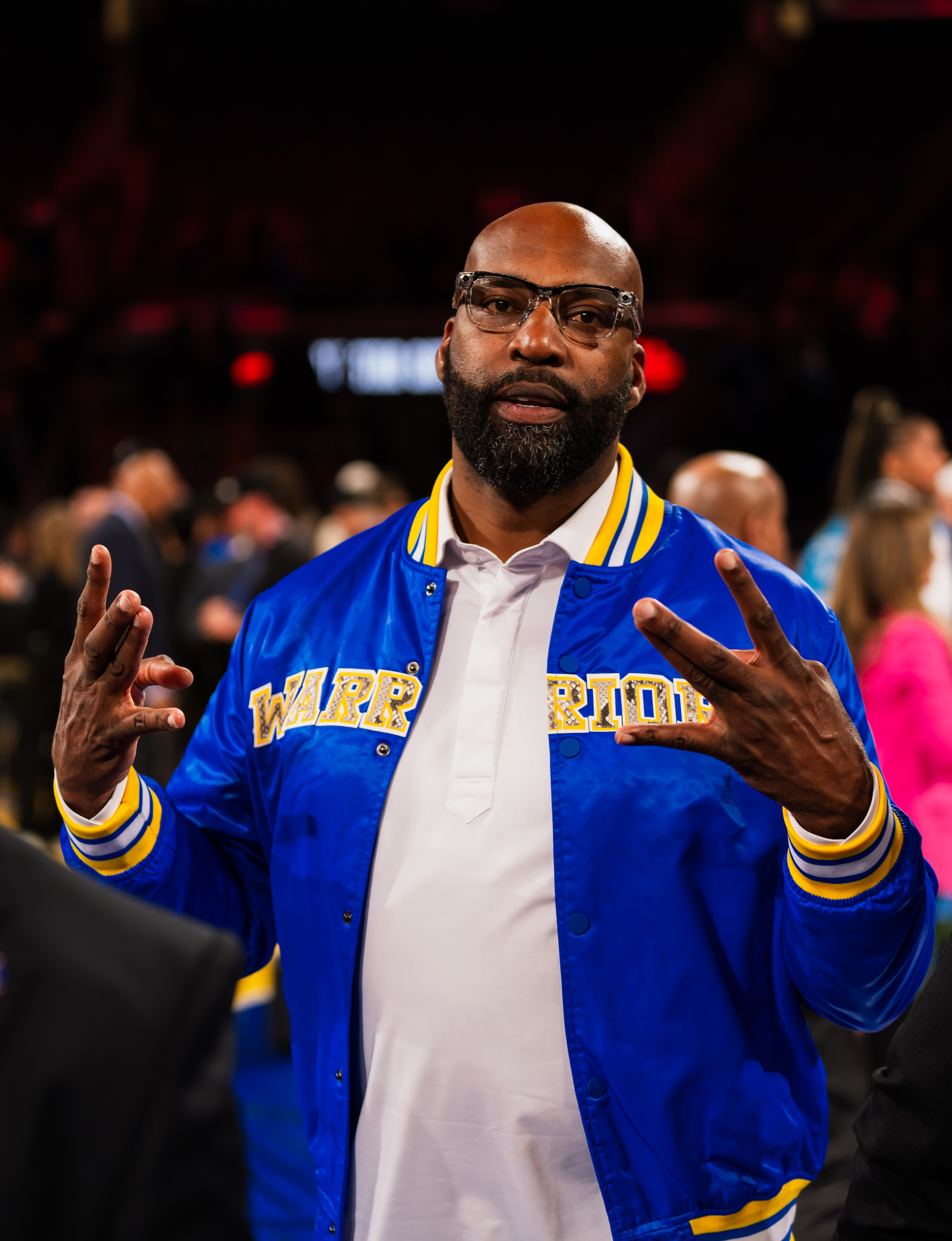 Man in Golden State Warriors varsity jacket at the 2025 NBA All-Star Game at Chase Center